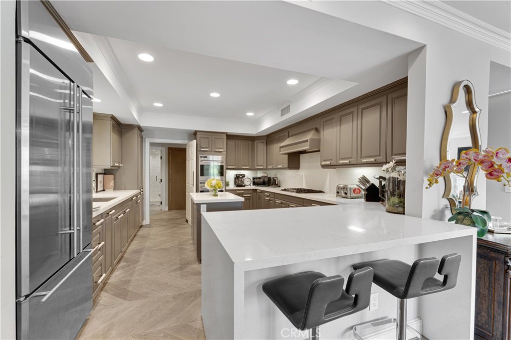 a kitchen with a sink a stove and chairs