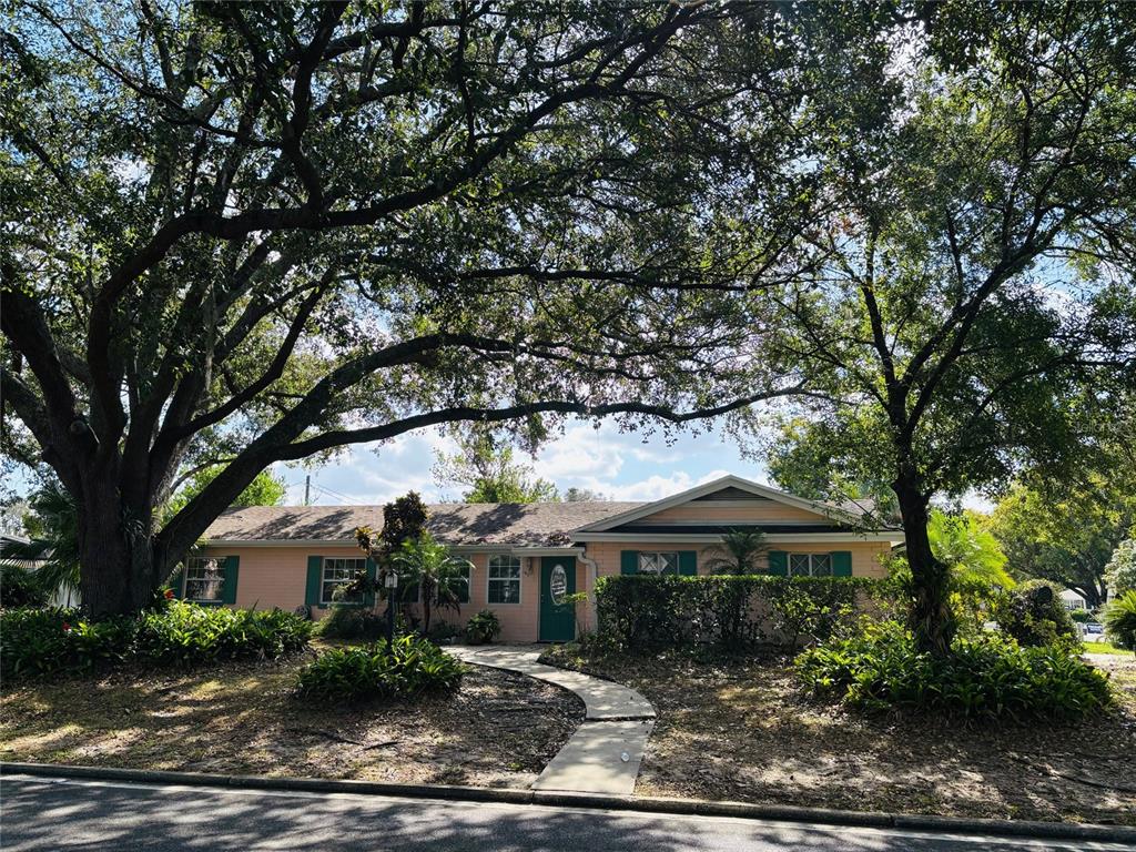 a front view of a house with a garden