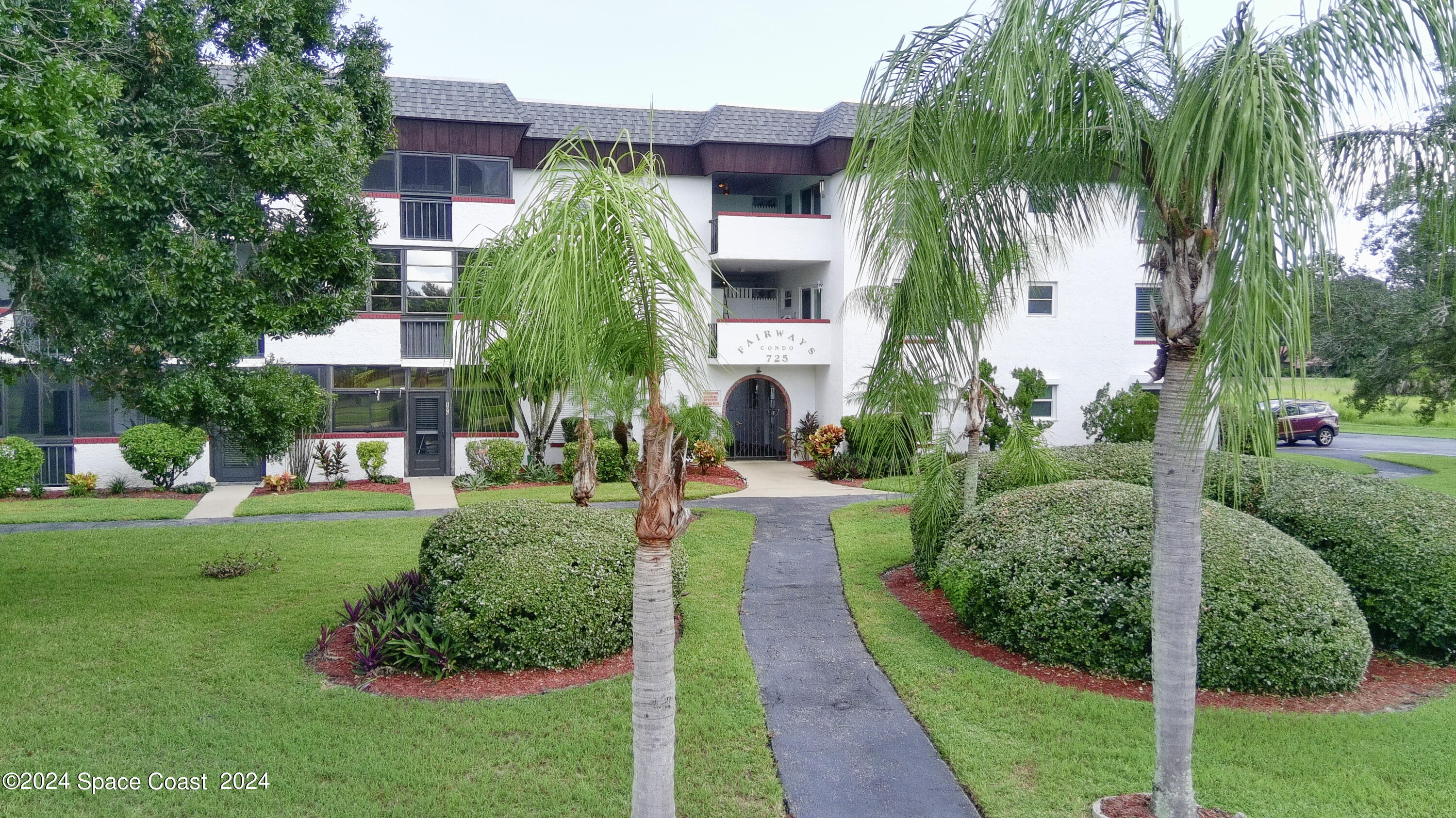 a view of a house with a yard and plants