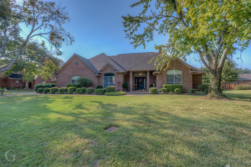 a front view of house with yard and green space