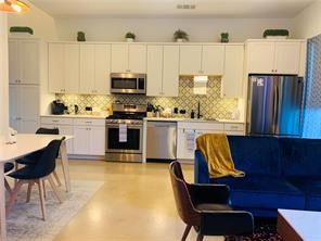 a view of kitchen with furniture and wooden floor