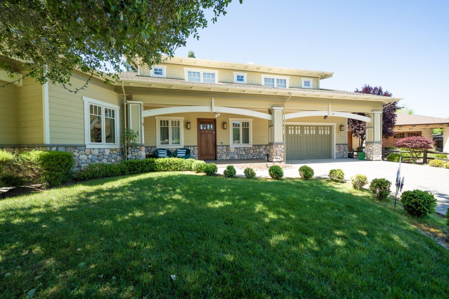 a front view of house with yard and green space