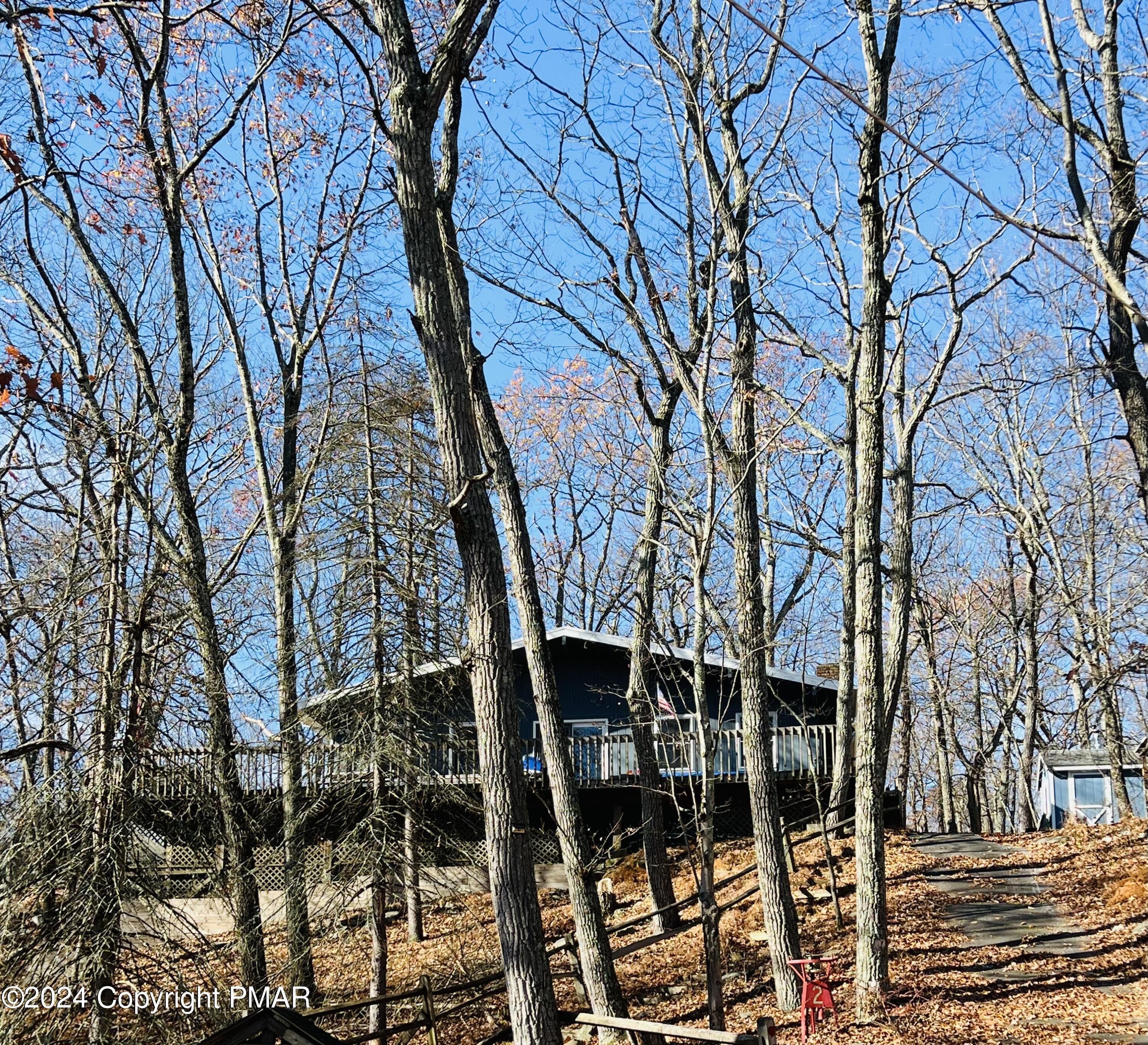 a backyard of a house with lots of trees