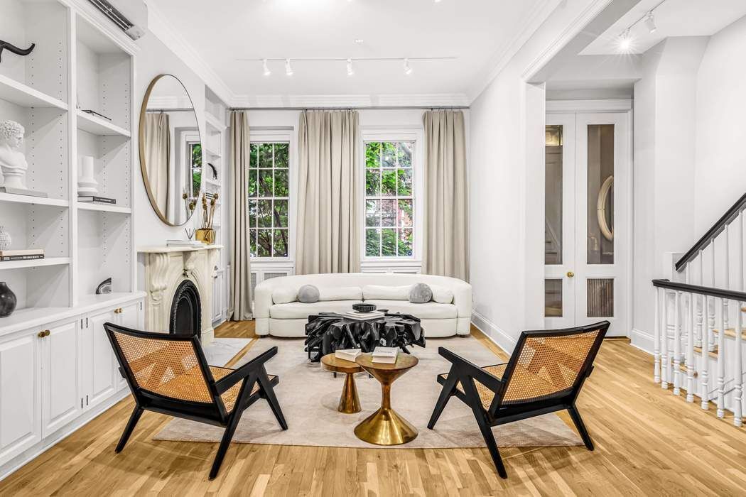 a living room with furniture a fireplace and a large window