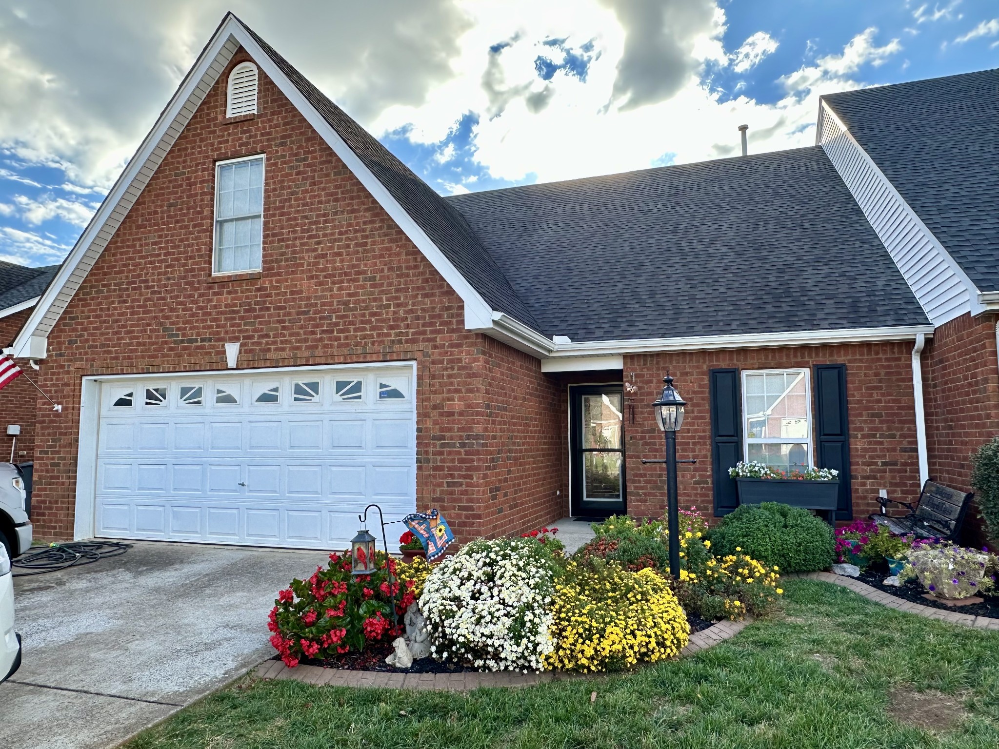 a front view of a house with a yard and potted plants