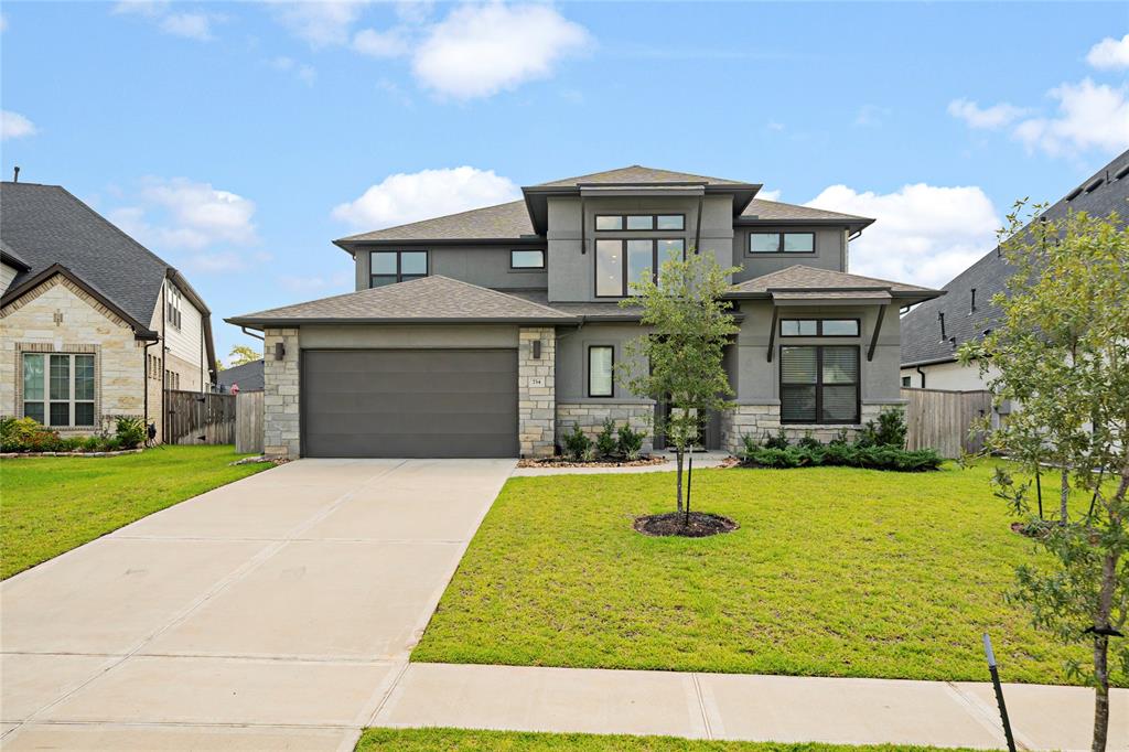 Welcome to this exquisite Dress Custom Home. Admire the beautiful exterior with stucco and stone.