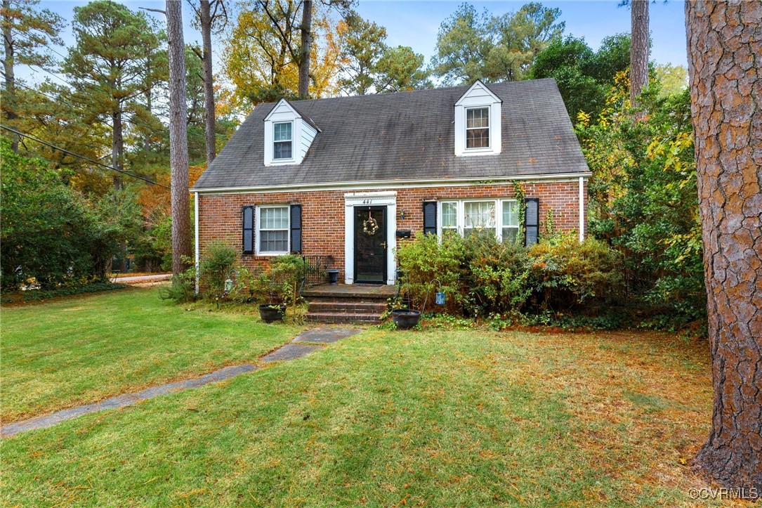 New england style home with a front yard