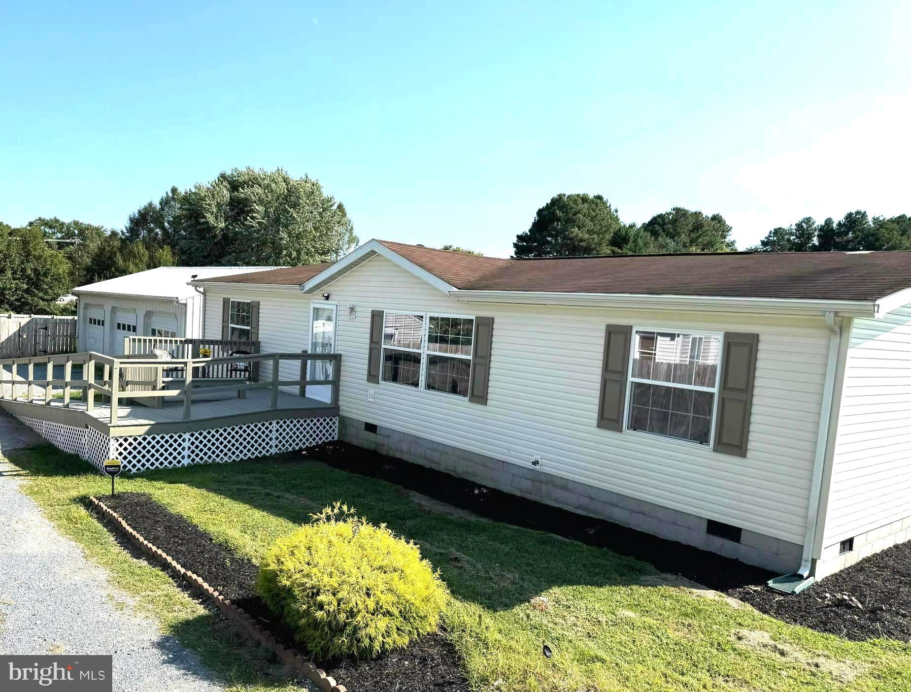 a view of a house with a wooden deck