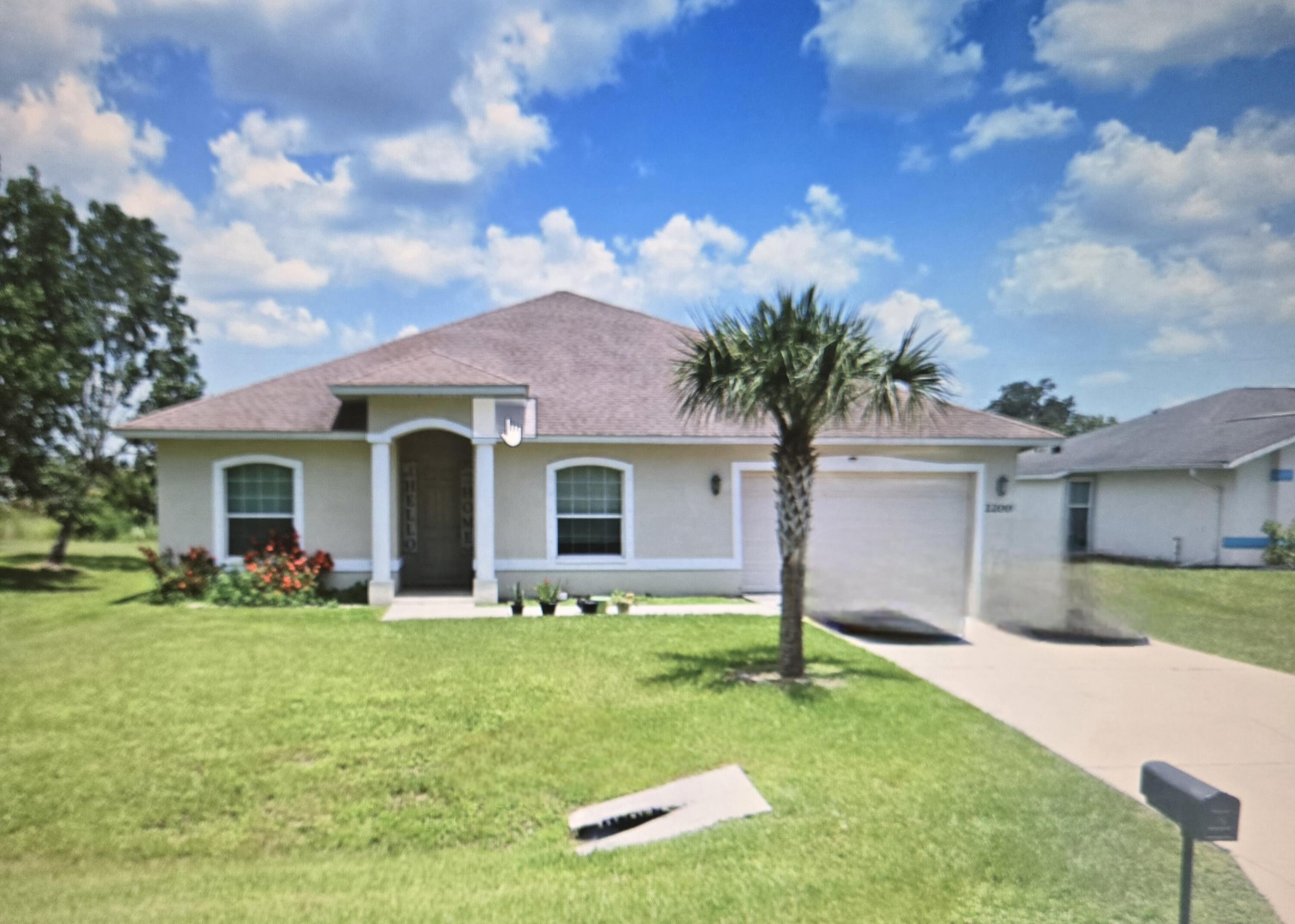 a front view of house with yard and green space