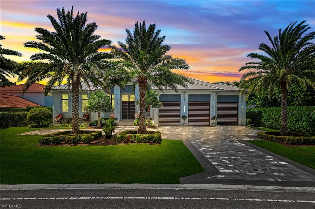 a front view of a house with a garden and patio