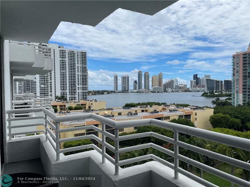 a view of a balcony with a yard