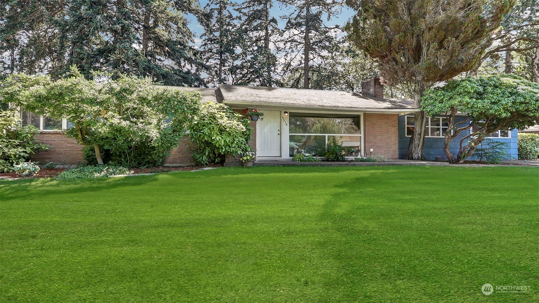 a view of a house with a yard and sitting area