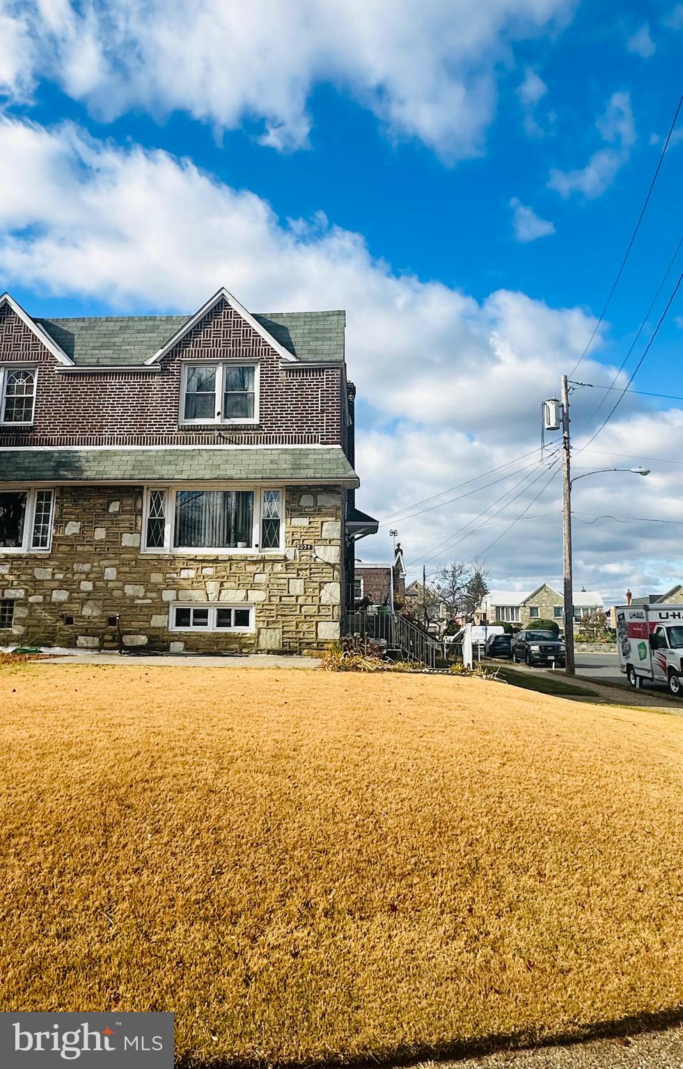 a front view of a house with yard and ocean view