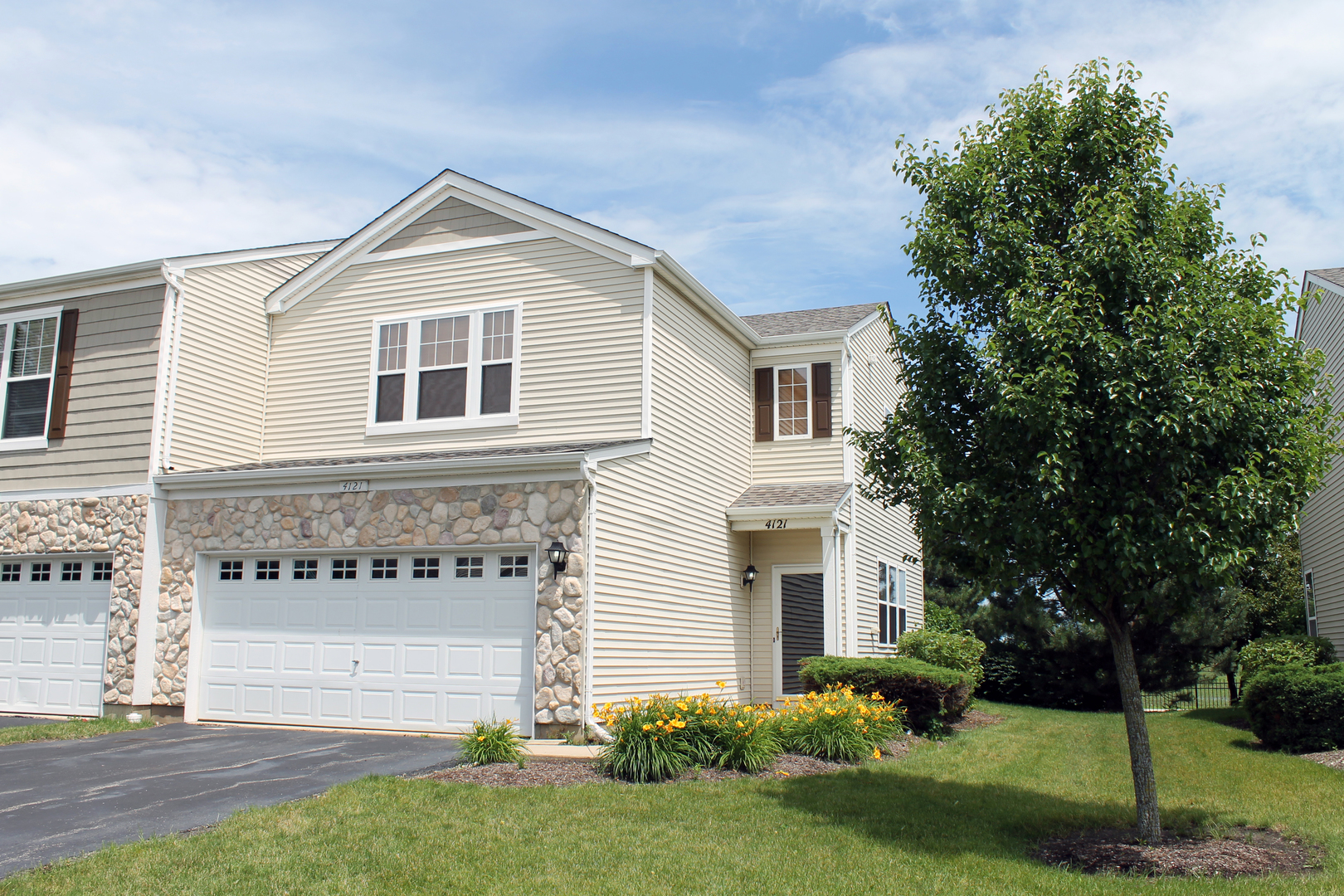 a front view of a house with a yard and garage