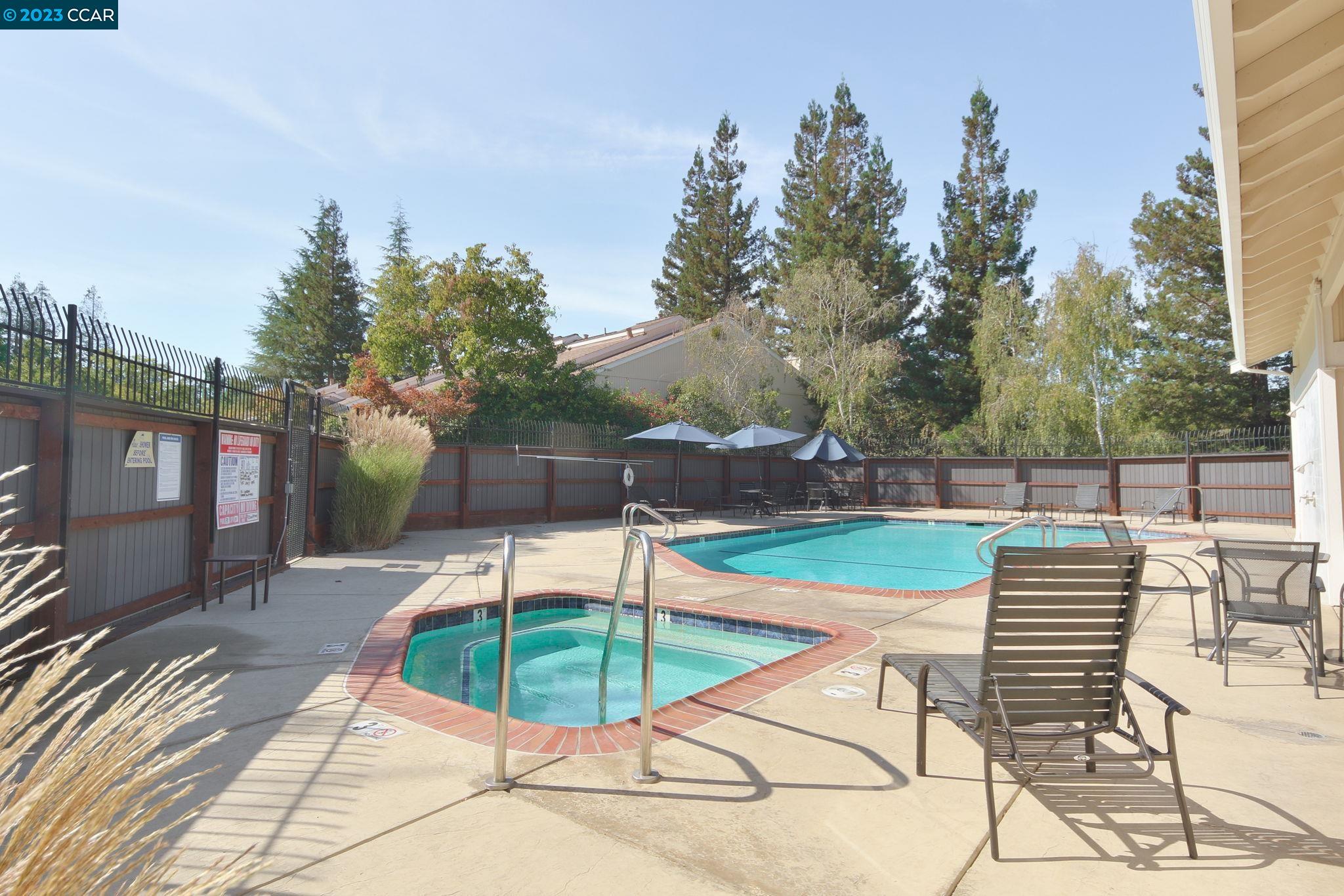 a view of a backyard with sitting area