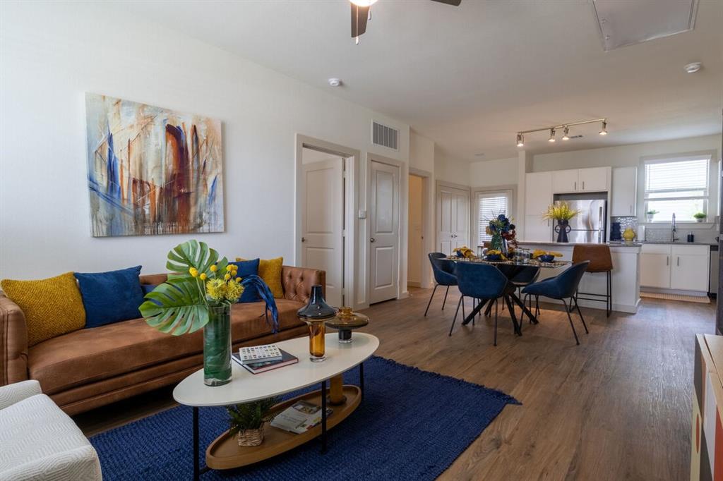 a living room with furniture and wooden floor