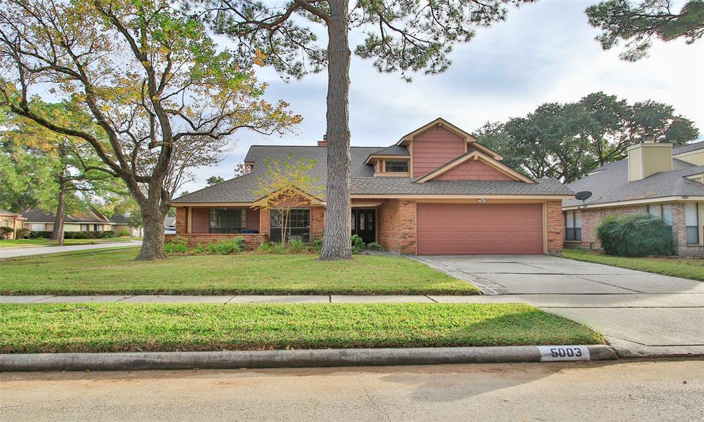 Large corner lot, with covered side porch & recent roof.