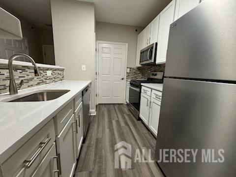 a kitchen with a sink a stove top oven and refrigerator