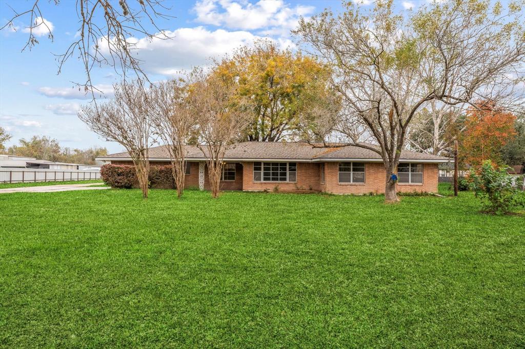 a front view of house with yard and green space