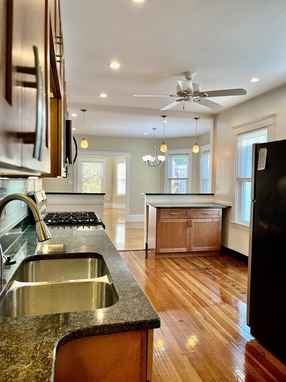 a kitchen with a refrigerator a sink and a stove top oven