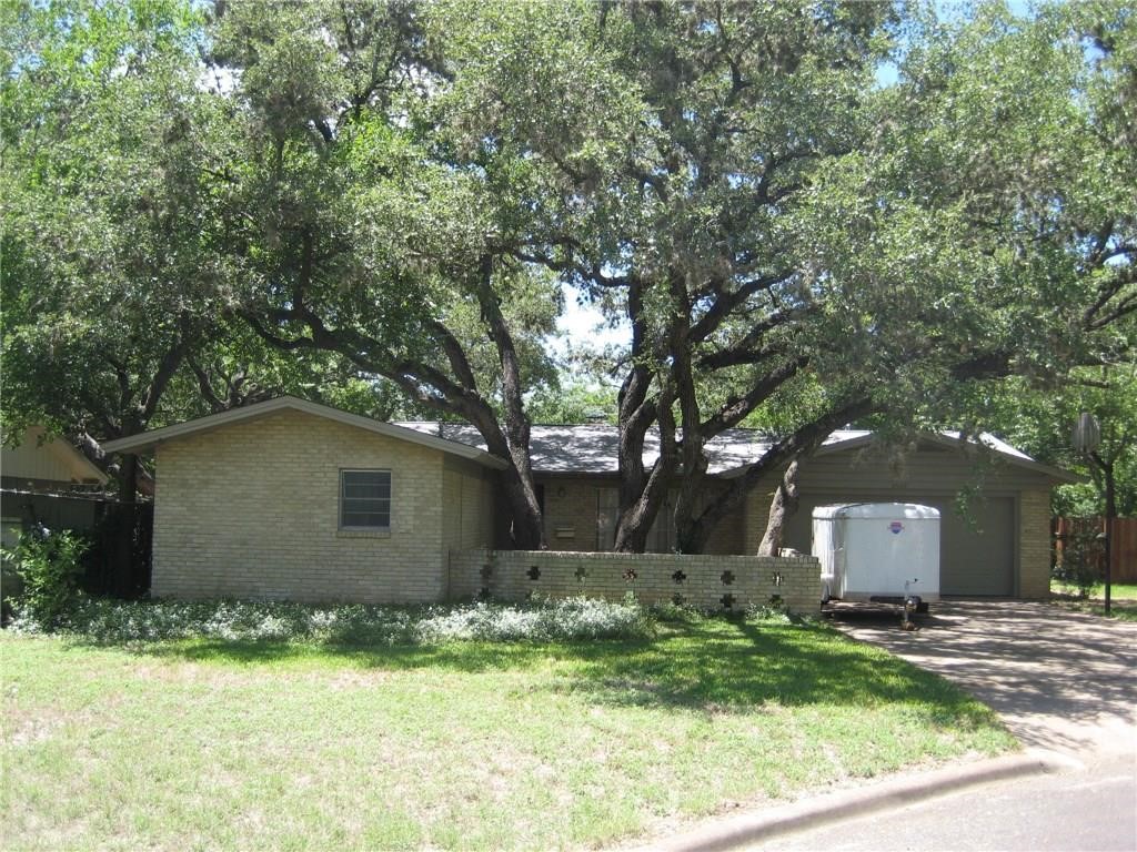 a house that has a tree in front of it