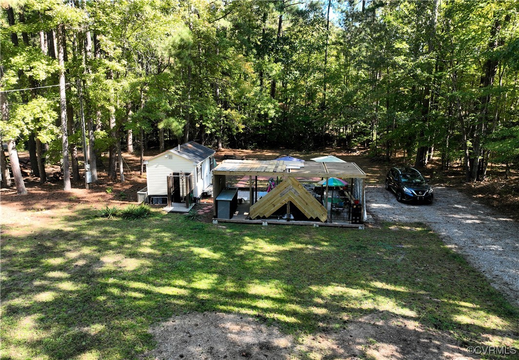 a view of a house with yard and sitting area