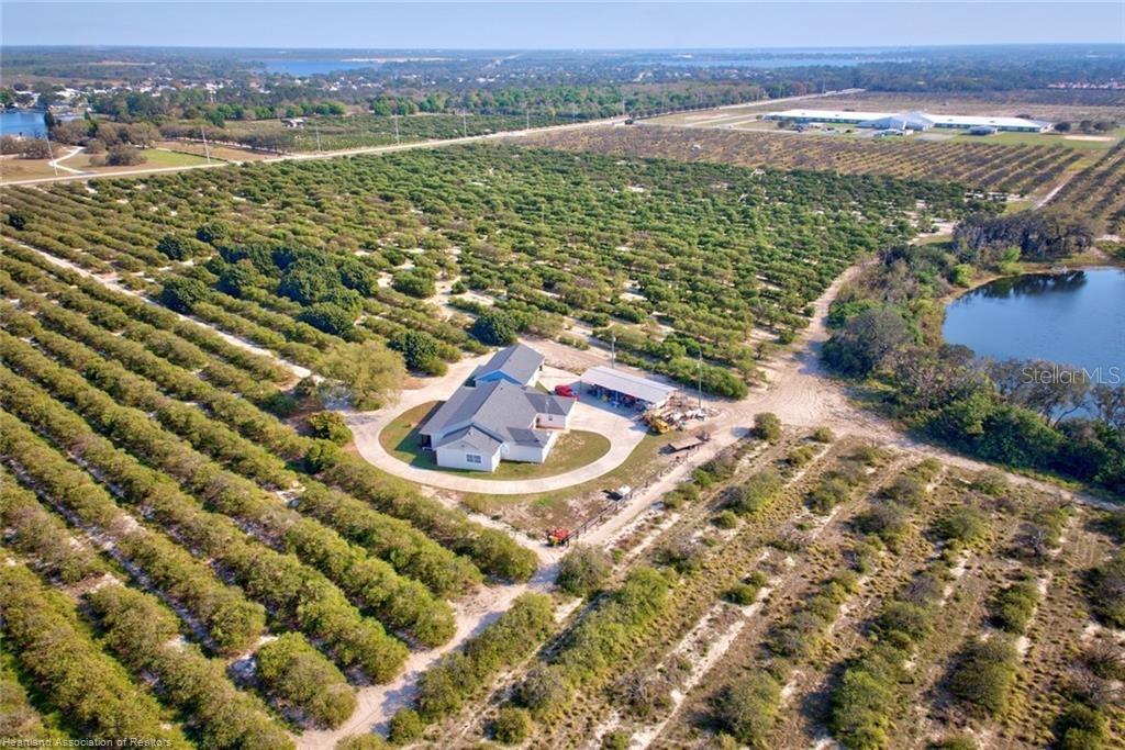 an aerial view of a houses with a yard