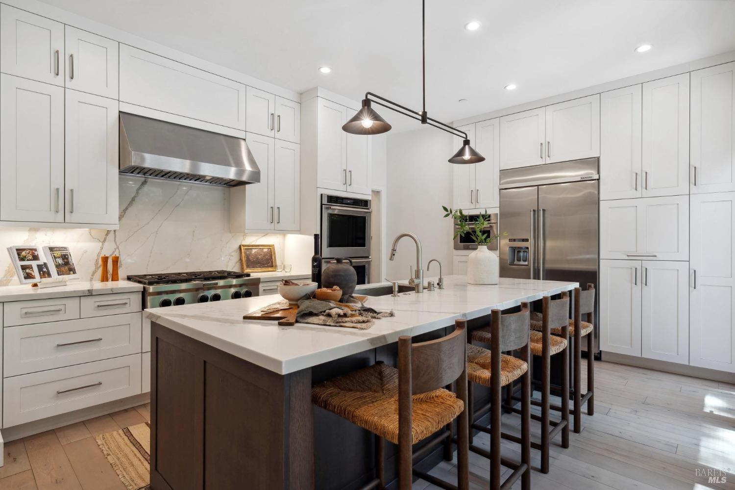 a kitchen with a table chairs stove and refrigerator