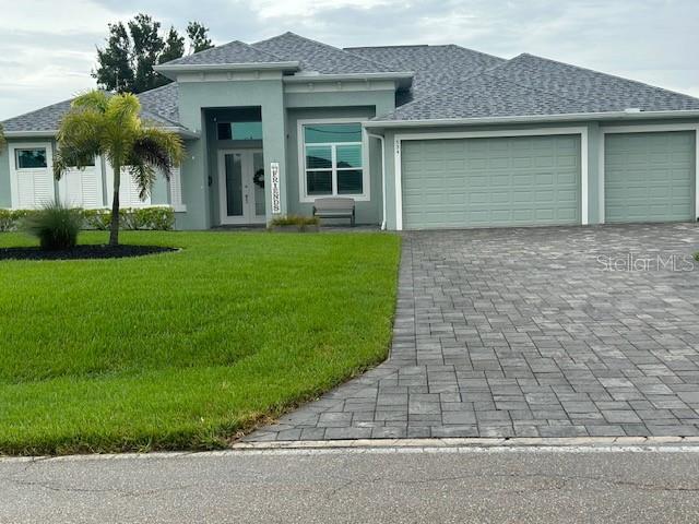 a front view of a house with a garden and plants