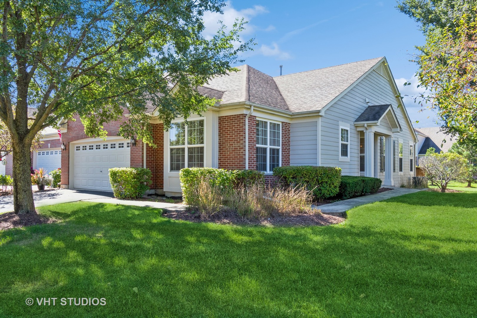 a view of a house with a yard and tree s