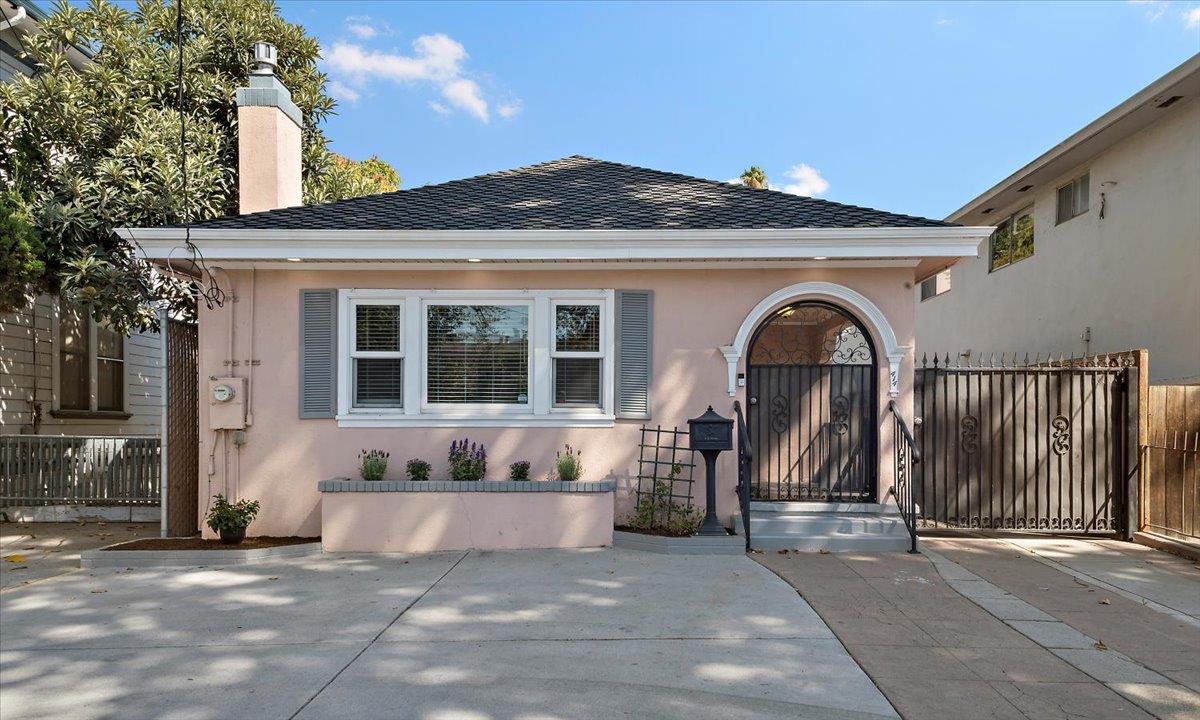 a front view of a house with a garden