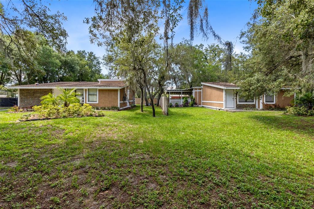 a view of a house with pool and a yard