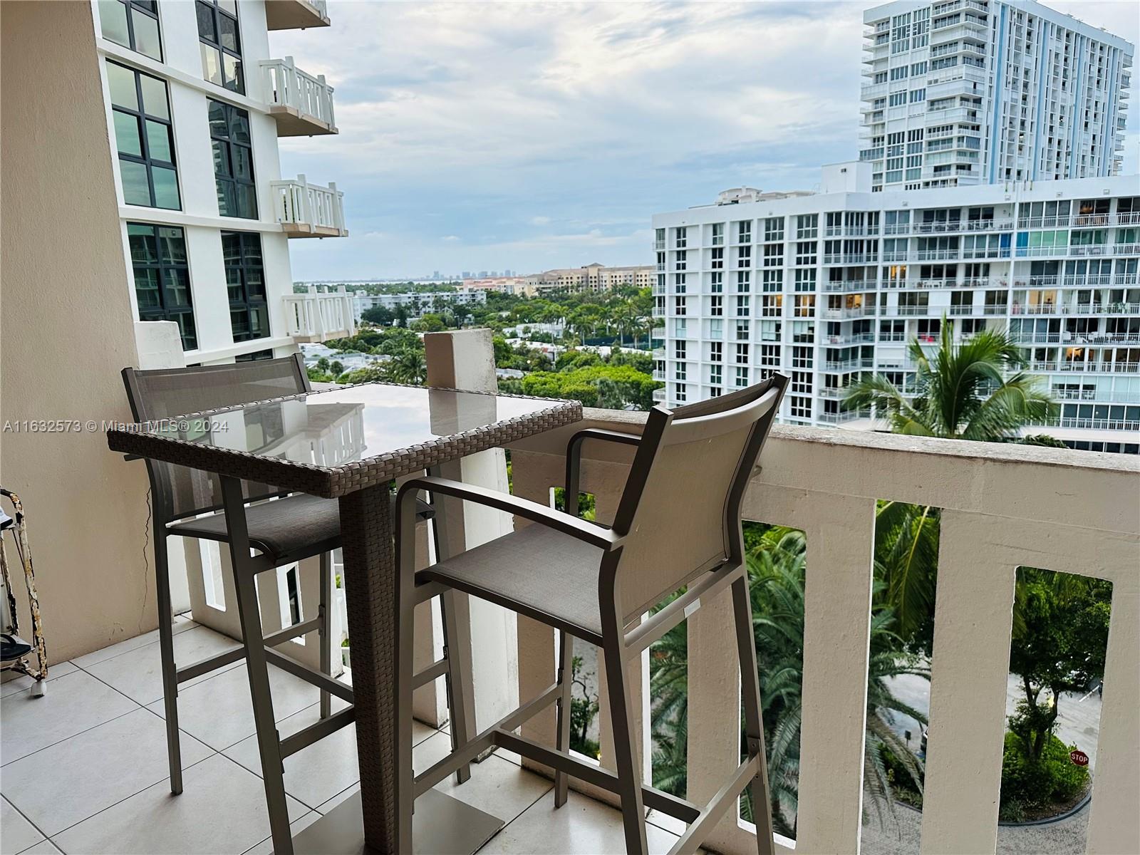 a roof deck with table and chairs and potted plants