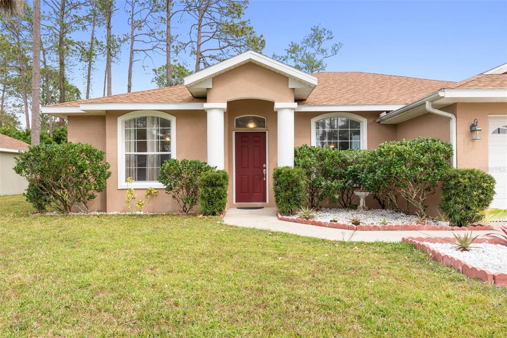 a front view of a house with a yard