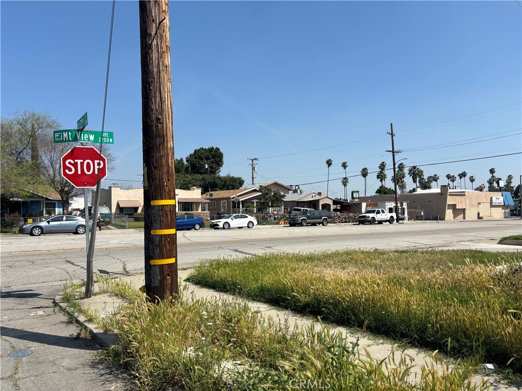 a view of a street with cars parked