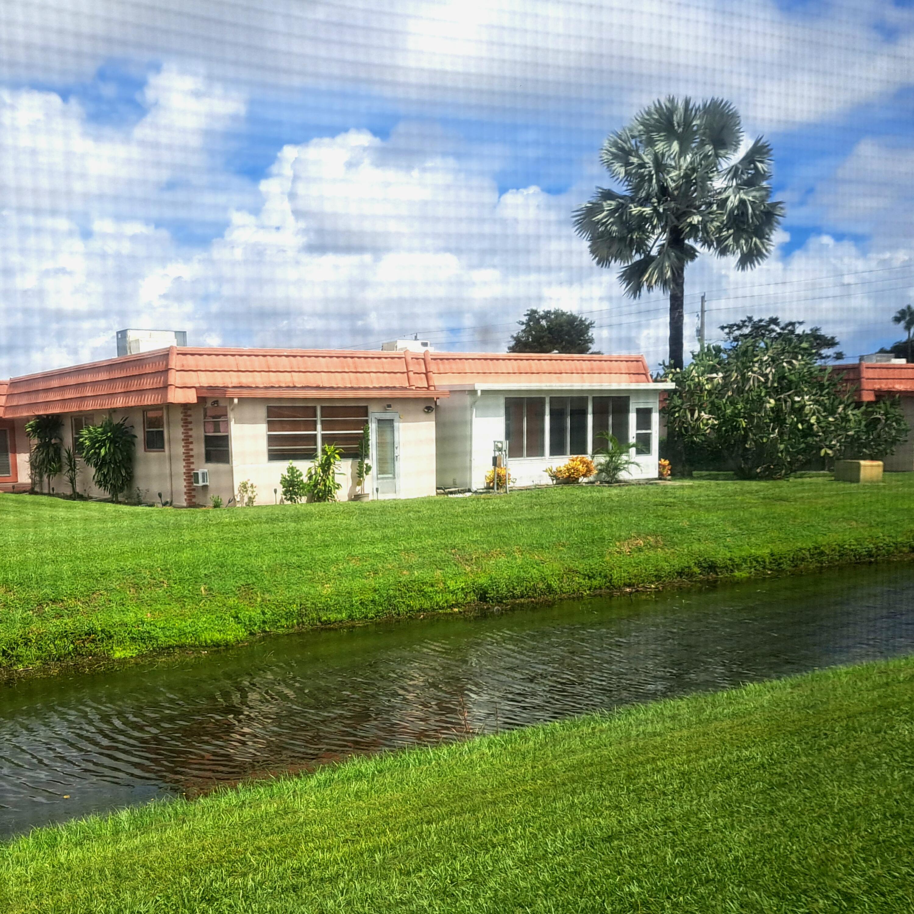 a front view of building with yard and green space