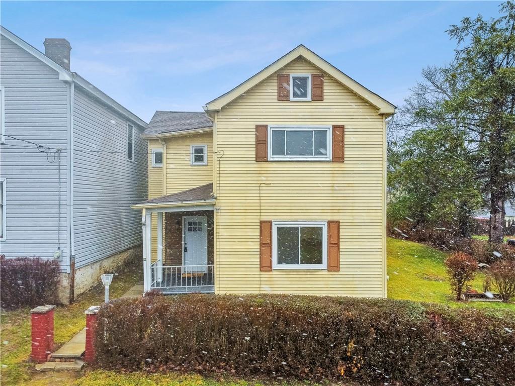 a front view of a house with a yard