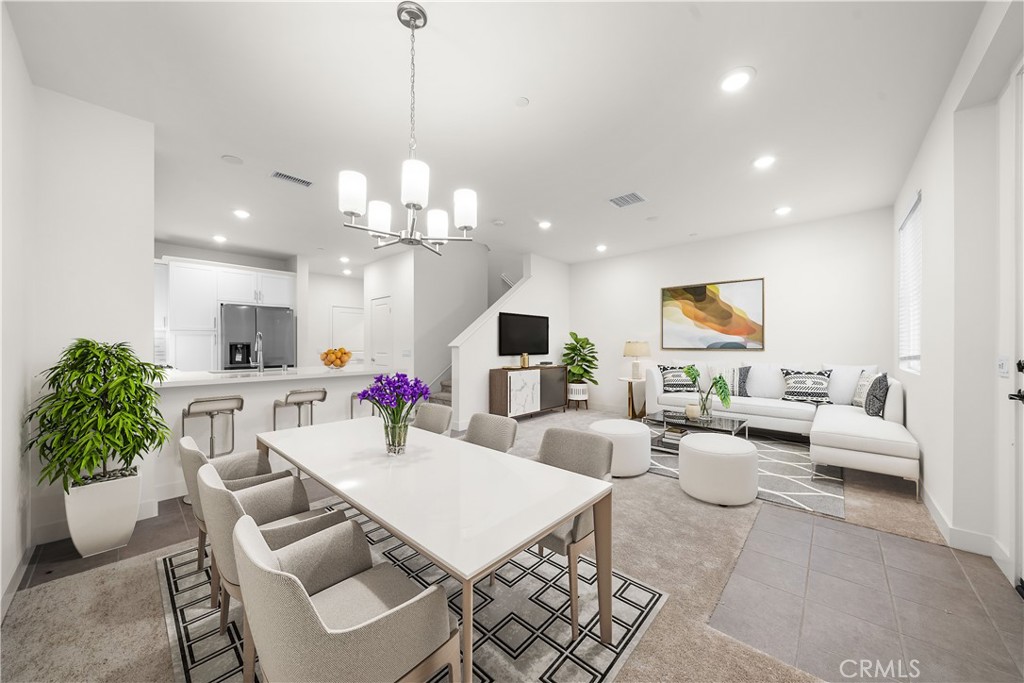 a living room with furniture a chandelier and a flat screen tv