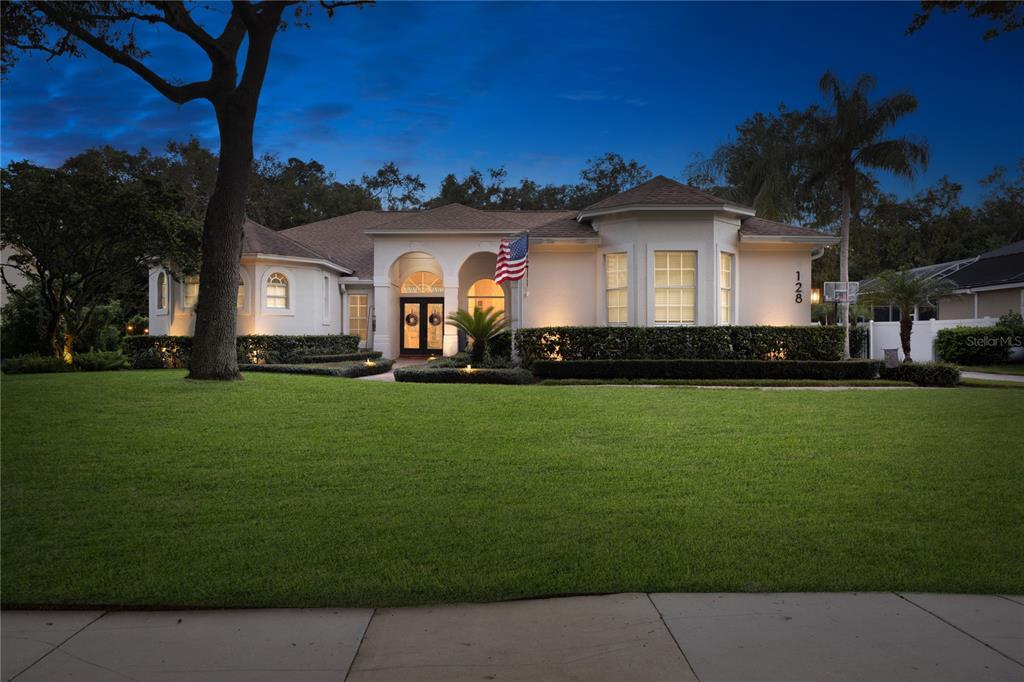 a front view of a house with a garden