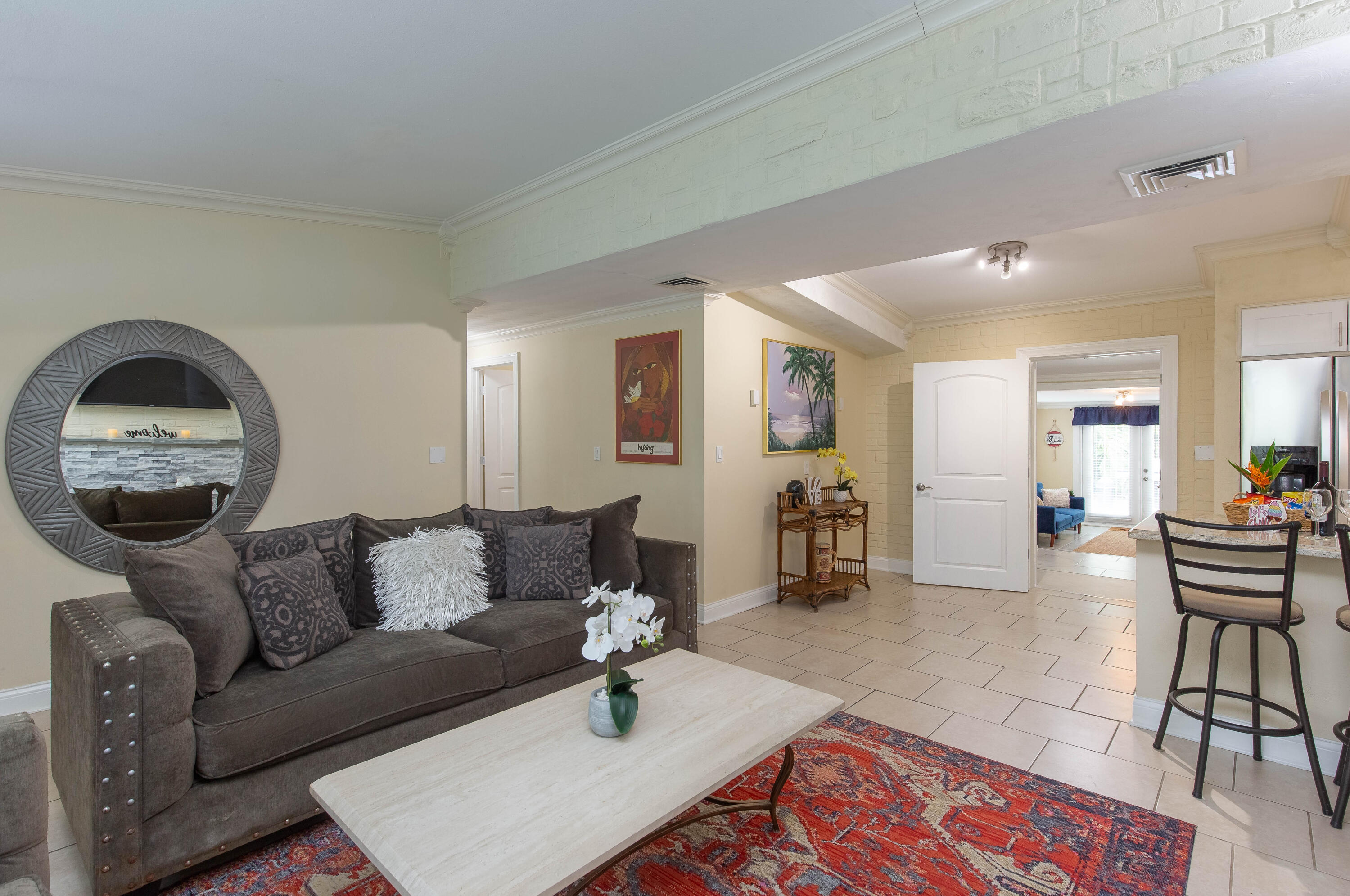 a living room with furniture and wooden floor