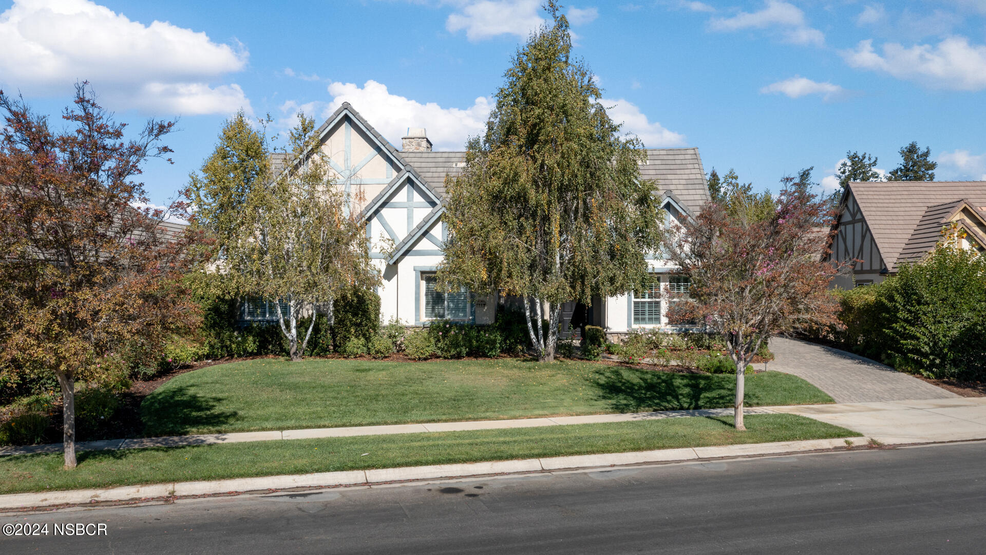 a view of a house with a yard and tree s