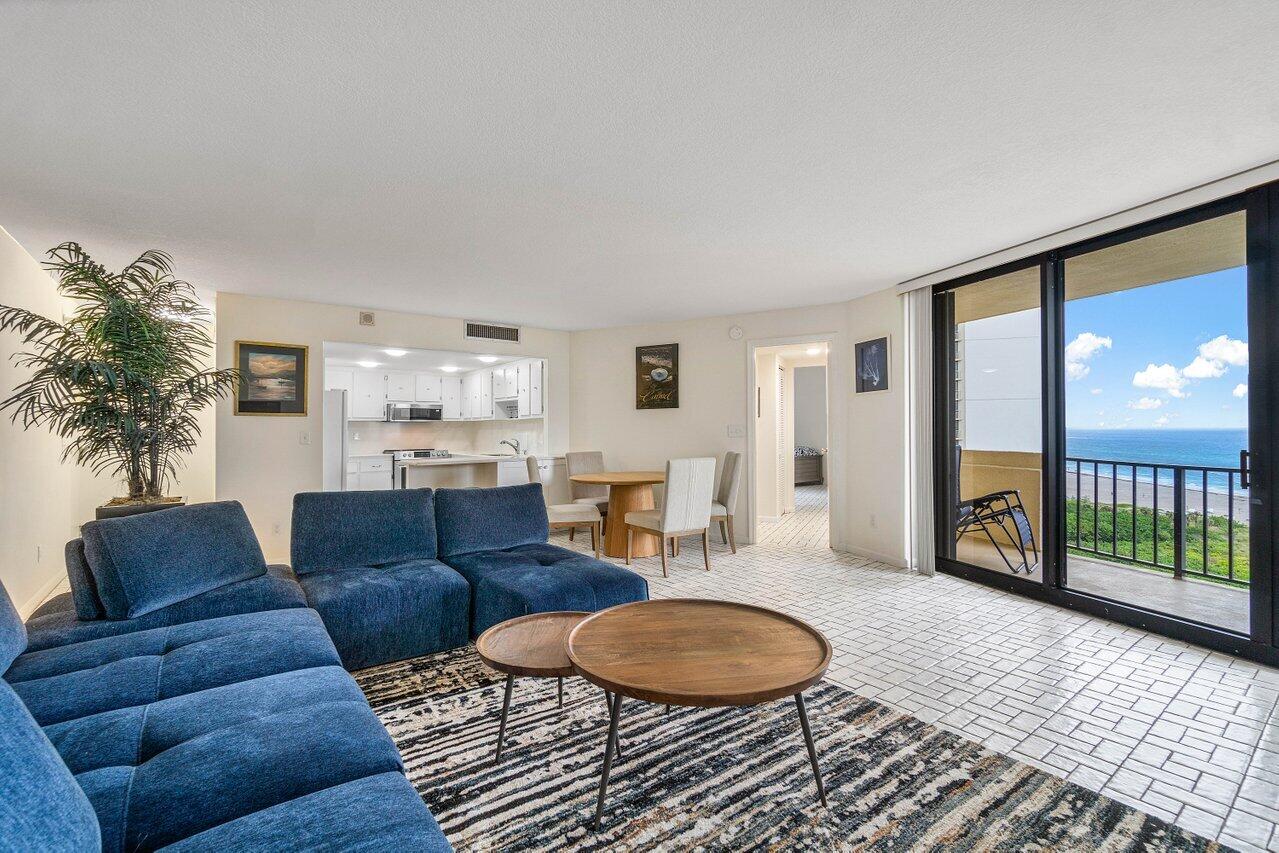 a living room with furniture and a floor to ceiling window