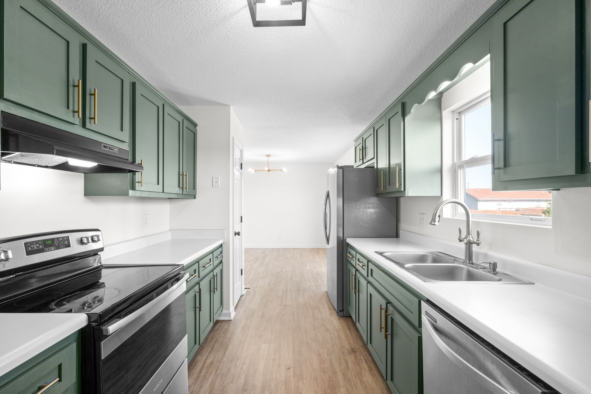 a kitchen with a sink stove and cabinets