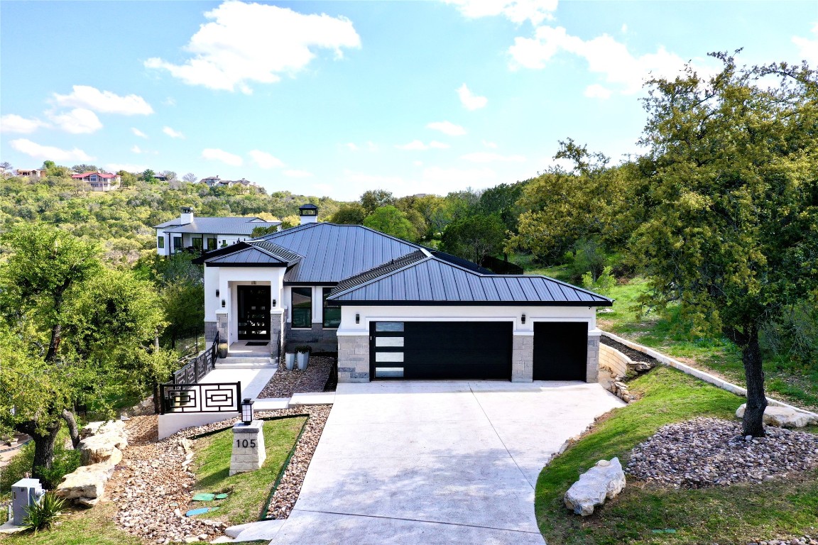 a front view of a house with a garden