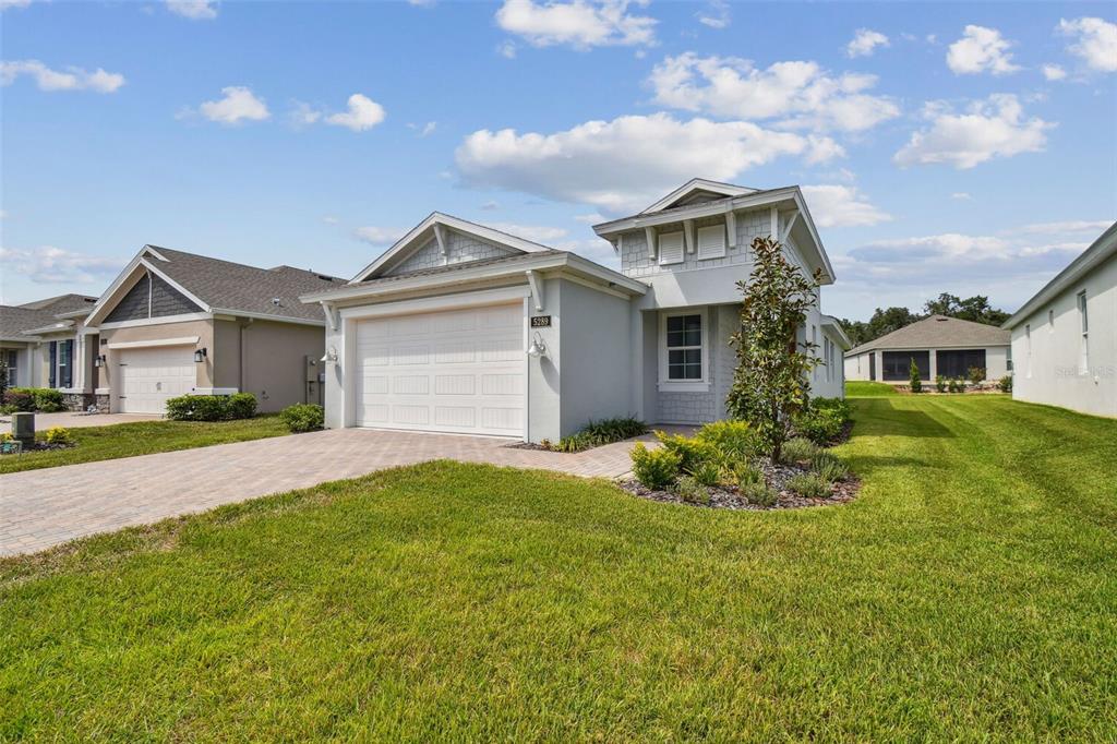 a front view of a house with a yard and garage