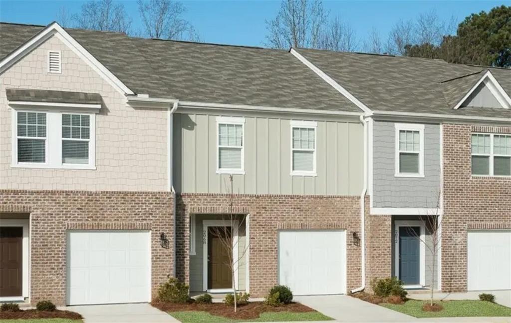 a front view of a house with a garage