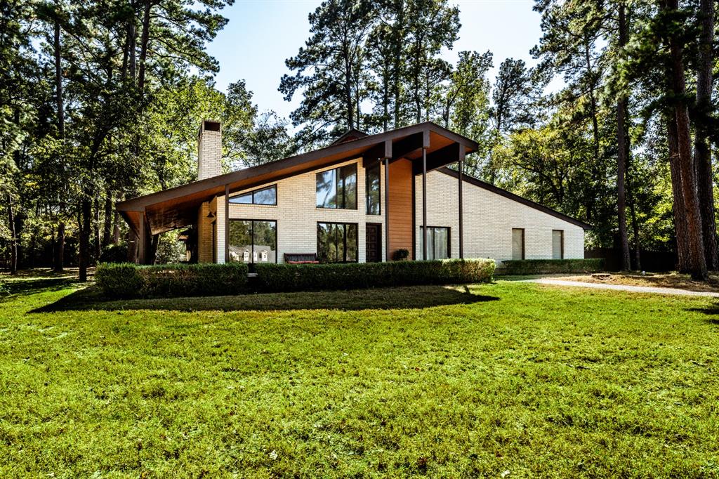 a front view of house with yard and trees