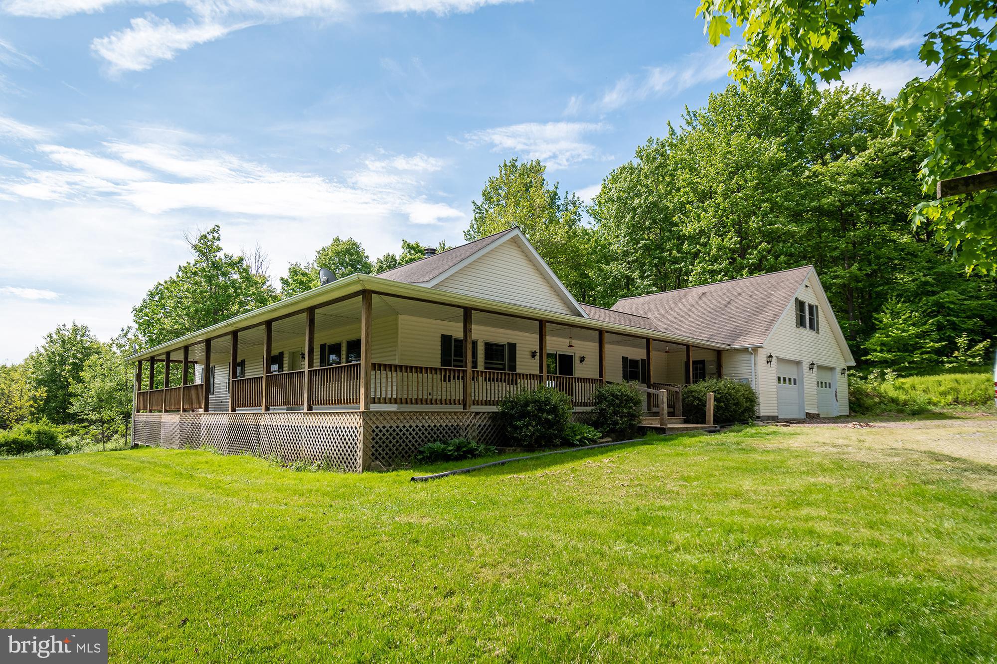 a front view of a house with yard patio and green space