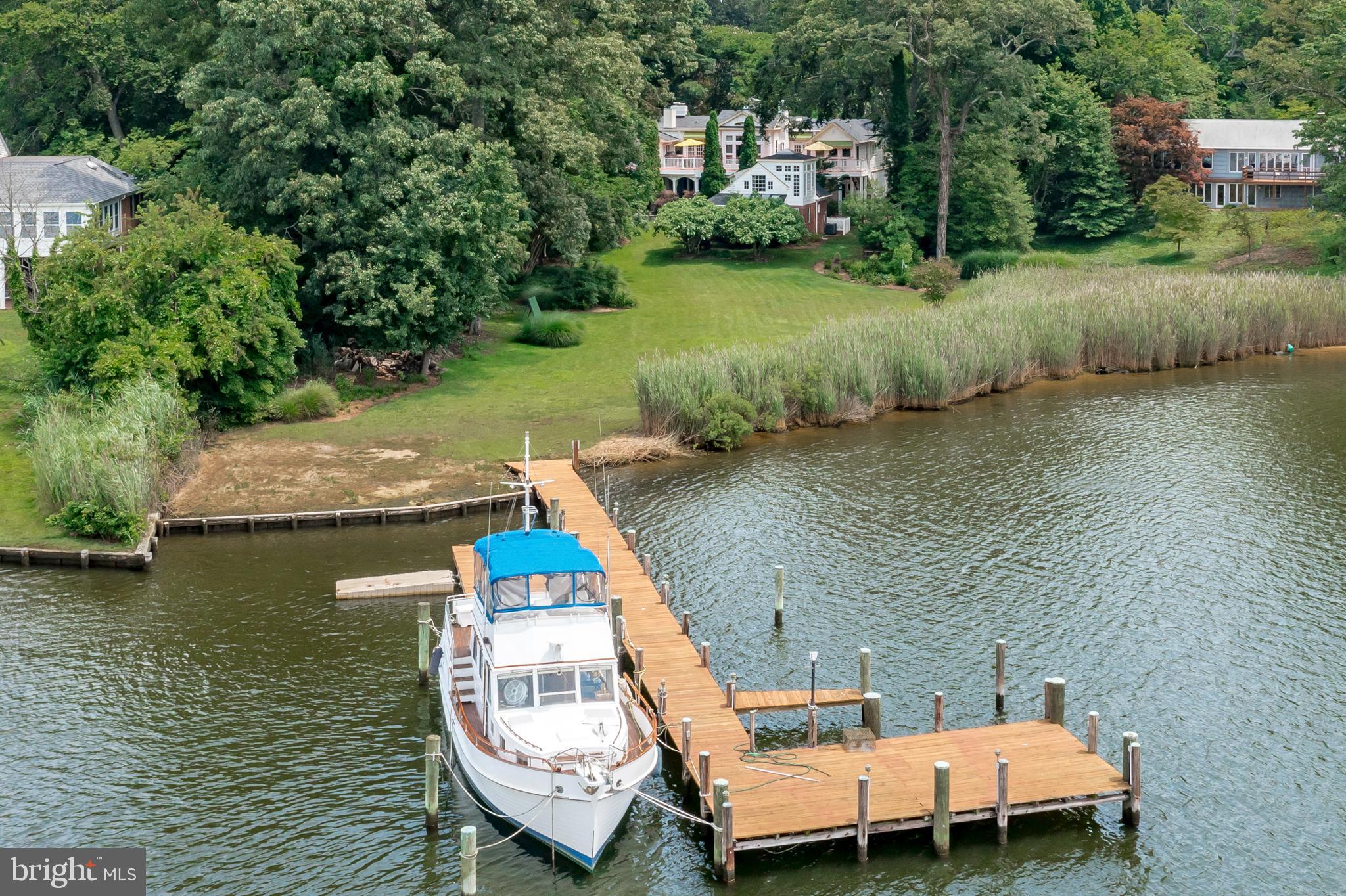 an aerial view of a house with swimming pool and lake view