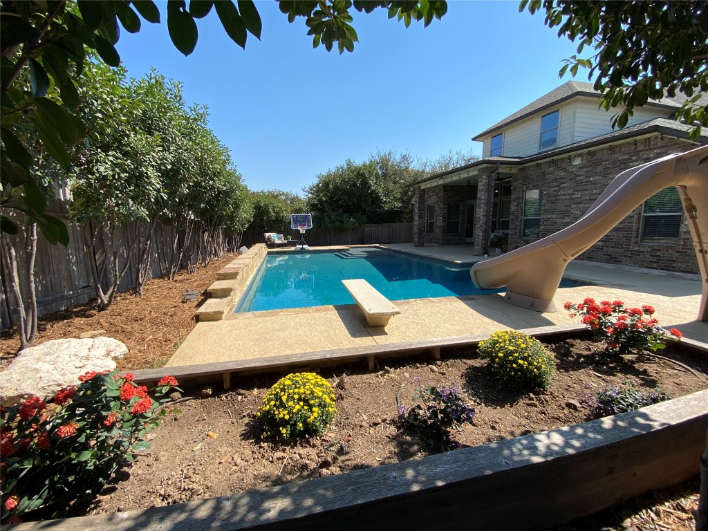 a view of a backyard with plants and lake view